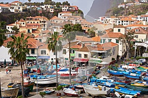 View of CÃÂ¢mara de Lobos in Madeira with Cape GirÃÂ£o on the background and boats at the marina, Portugal