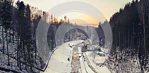 View from the dam in Miedzygorze, flowing river in a mountain valley in winter