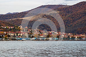 View of Danube river and Orsova city vegetation and buildings, waterfront view. Orsova, Romania, 2021