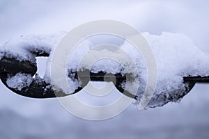 View of dark black chain covered with snow winter russia Arkhangel