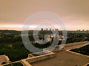 A view of the of the dark smoky hazy orange and brown skies above the river valley in in downtown Edmonton, Alberta, Canada
