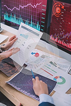 View of data analysts using charts while developing software for computer systems