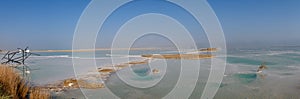 View of Dead Sea coastline with it`s beautiful sand and salt in the middle of the water. Aerial shot captured from the