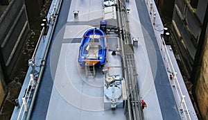 View on deck of inland barge with pipes and boat