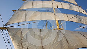 A View from the Deck Looking Upwards at the Mast, Blown Sails and Rigging of a Big Sailing Ship. Vertical perspective.
