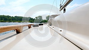 View from the deck of a small sailing yacht on the river.