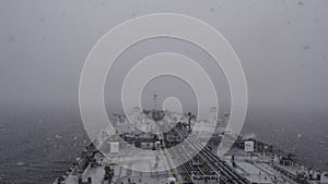 View of the deck of a tanker in a blizzard, snowy weather