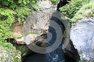 View of deep Khadzhokh Gorge with white rocks in summer