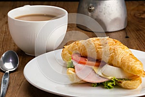 View of delicious ham cheese croissants and hot milk coffee for breakfast