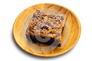 View of delicious homemade chocolate toffee cake topping with cashew nut and caramel in wooden plate