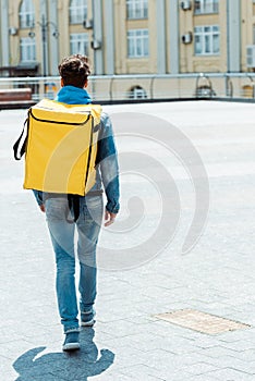 View of delivery man carrying thermo