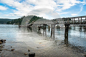 View of a Deserted Wooden Pier in a Harbour on a Cloudy Summer Day