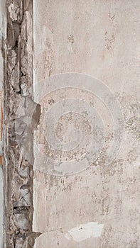 View of destroyed white concrete wall, wall mountings, rough background, grunge background