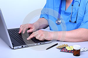 View of Details of doctor hands typing on keyboard