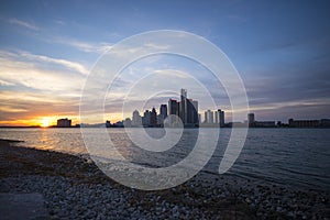 View of Detroit city skyline at sunset from the shore of the riv