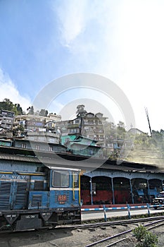 View of diesel locomotive and houses built on the hillside, along the Darjeeling Himalayan Railway, West Bengal, India
