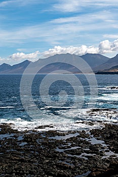 View on difficult to access golden sandy long Cofete beach hidden behind mountain range on Fuerteventura, Canary islands, Spain