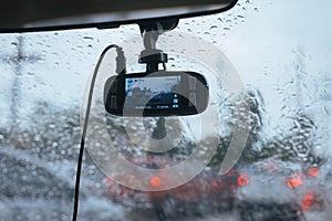 View from digital camera inside car window with rain drops on glass or the windshield,Blurred traffic on rainy day