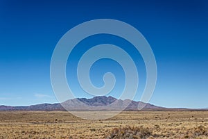 View of distant mountains across high desert plain in New Mexico USA