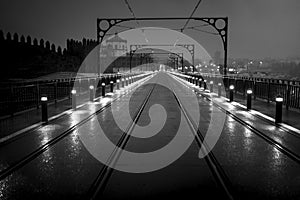 A view of the Dom Luis I Bridge at night in Porto, Portugal. Black and white photo.