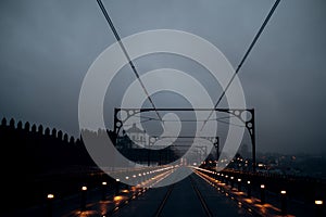 View of the Dom Luis I Bridge and railway tracks at night, Porto