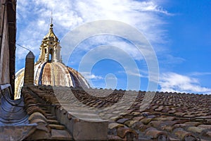 View at the dome of Saint Peter`s Basilica and tiled roof in Vatican City, Rome, Italy.