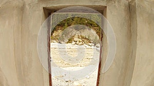 View through doorway on river Ganga with dark Impetuous stream