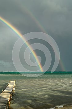 View of double rainbow over the ocean.