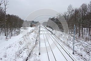 A view of the double track railway trail in winter scenery.