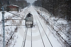 A view of the double track railway trail in winter scenery.