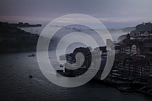 View of the Douro River in downtown in the fog during dusk, Porto, Portugal.