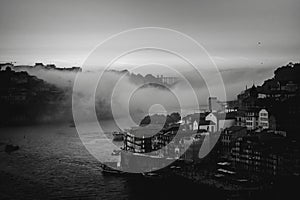 View of the Douro River in downtown in the fog during dusk, Porto, Portugal.