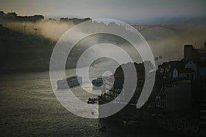 View of the Douro River in the fog at dusk, Porto, Portugal.