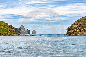 View down Cook`s Cove to sea and pinnacle shaped rocks