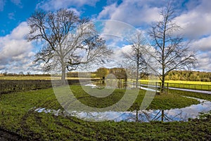 A view down a flooded lane near to Pitsford Reservoir, UK