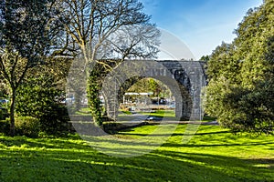 A view down the grassy bank of  the Green towards the railway viaduct in the seaside town of Tenby, Pembrokeshire