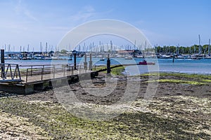 A view down a landing stage at low tide across the River Hamble