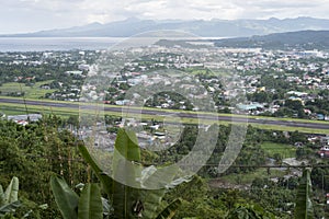 View down on Legazpi, the Philippines, from the hill. With view of the sea and the airport tarmac