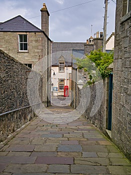 A view down the pedestrian, stone flagged Queens Lane to Commercial Street in the town centre of Lerwick, capital of Shetland