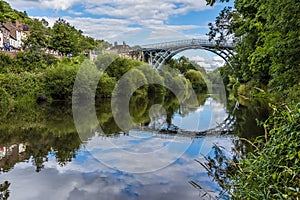 The view down the River Severn of the town of Ironbridge, Shropshire, UK and the bridge that gave it its name