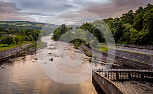 A view down the River Tummel at sunset from Pitlochry dam, on a cloudy evening photo