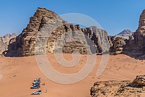 A view down from a sand dune towards rocky outcrops in the desert landscape in Wadi Rum, Jordan