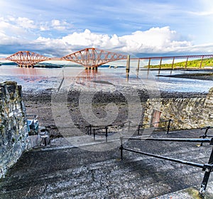 A view down steps to the beach in Queensferry then out across the Firth of Forth, Scotland