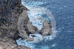 View down on waves crashing against coastal cliffs at Mirador Es Colomer Formentor, Mallorca, Spain