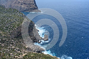 View down on waves crashing against coastal cliffs at Mirador Es Colomer Formentor, Mallorca, Spain