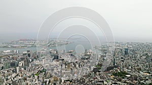 View of downtown Kobe City, Port Island, and harbor on sunny day