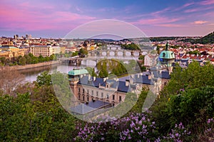 View on downtown Prague bridges and river from romantic Letna view point during early sunset with dusk pink