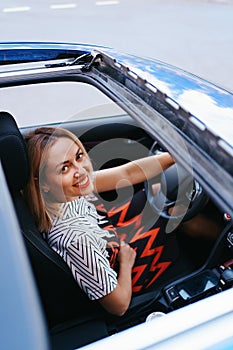 View of a driving woman through sunroof