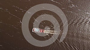 View from a drone of the cable car across the Volga going down the river tugboat