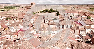View from drone of Cervera de la Canada cityscape overlooking fortified Catholic church of Iglesia de Santa Tecla, Spain